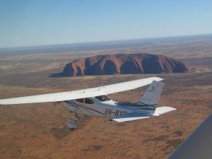 Curtis Aviation's Cessna 182, BXO, about to start the scenic pattern around Uluru & the Olgas. 