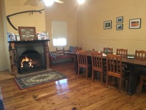 Your sleeping quarters come with this warm and welcoming dining room and cozy fireplace.